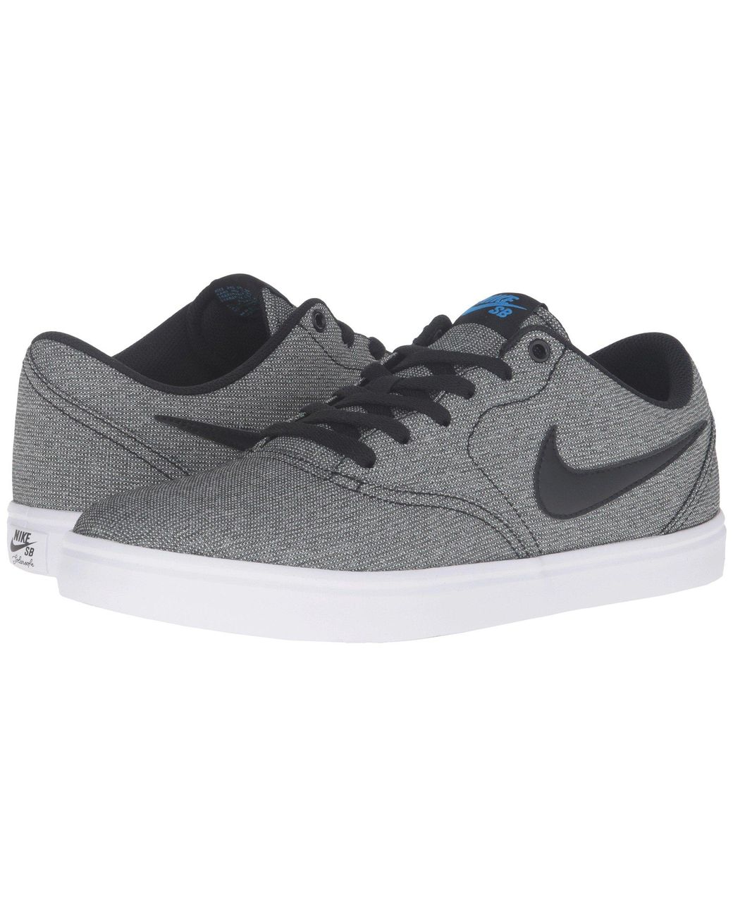 white nike shoes with blue check