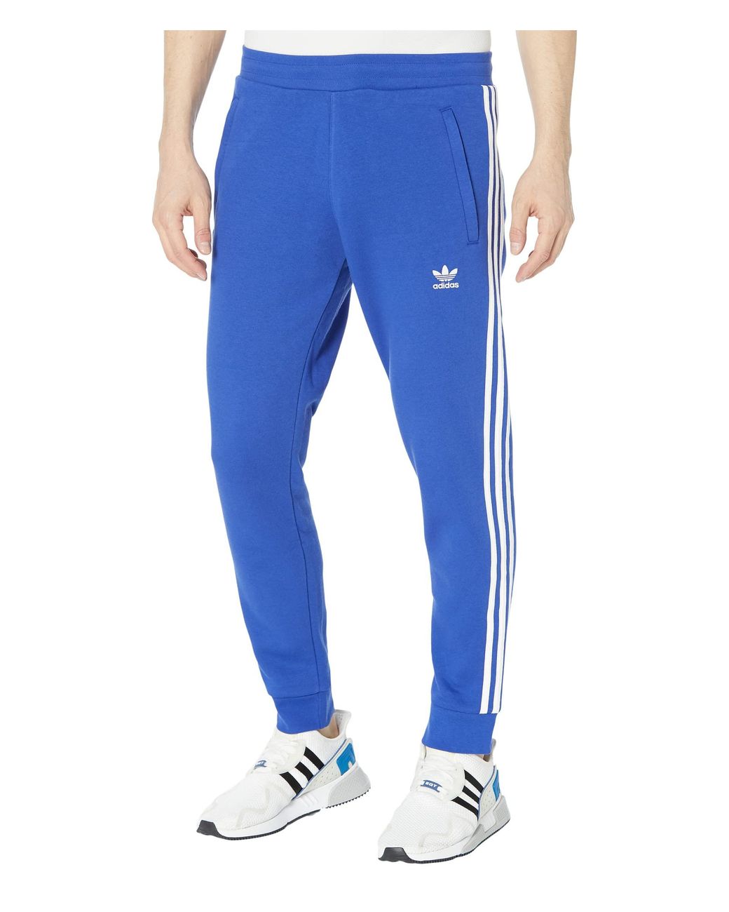 adidas Essentials Fleece Tapered Cuff 3-Stripes Pants - Blue | adidas India
