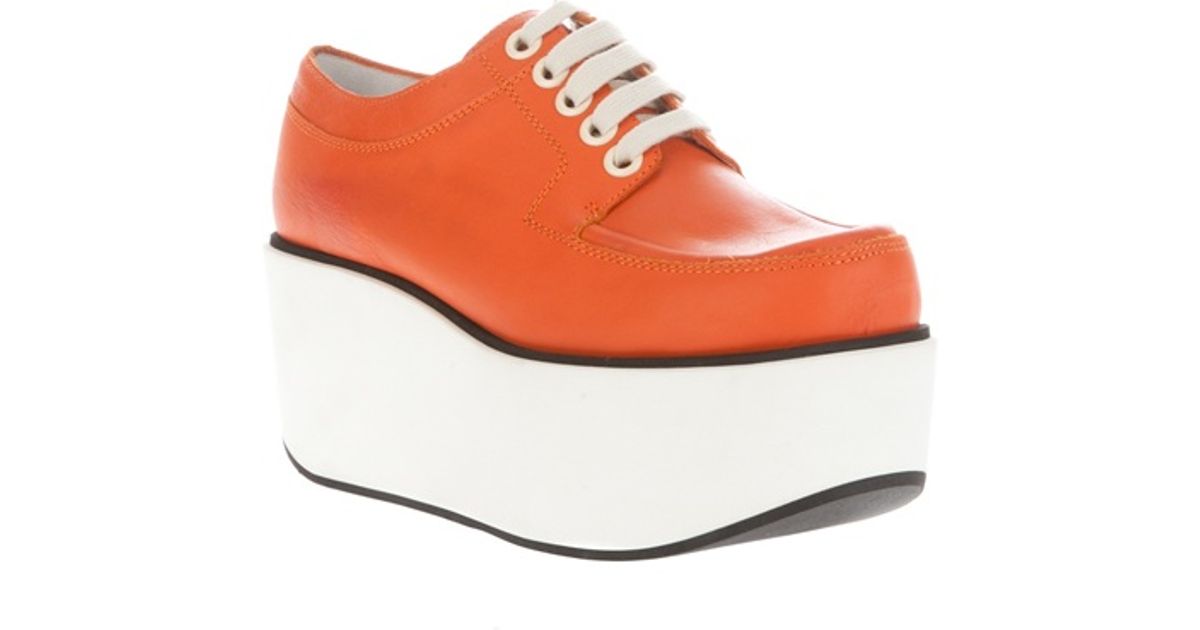 orange platform trainers