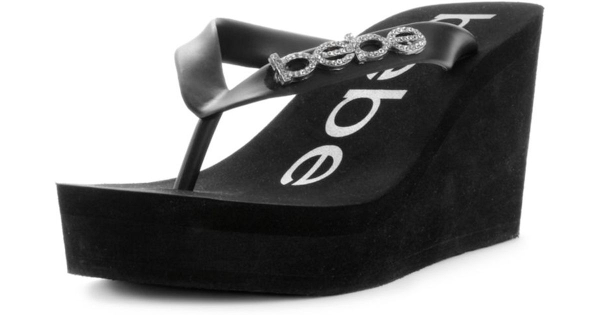 Bebe Kristy Wedge Flip Flop Sandals in Black | Lyst