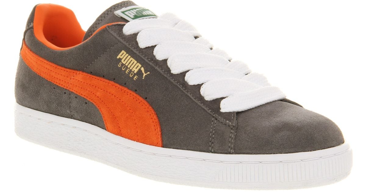 gray and orange puma shoes