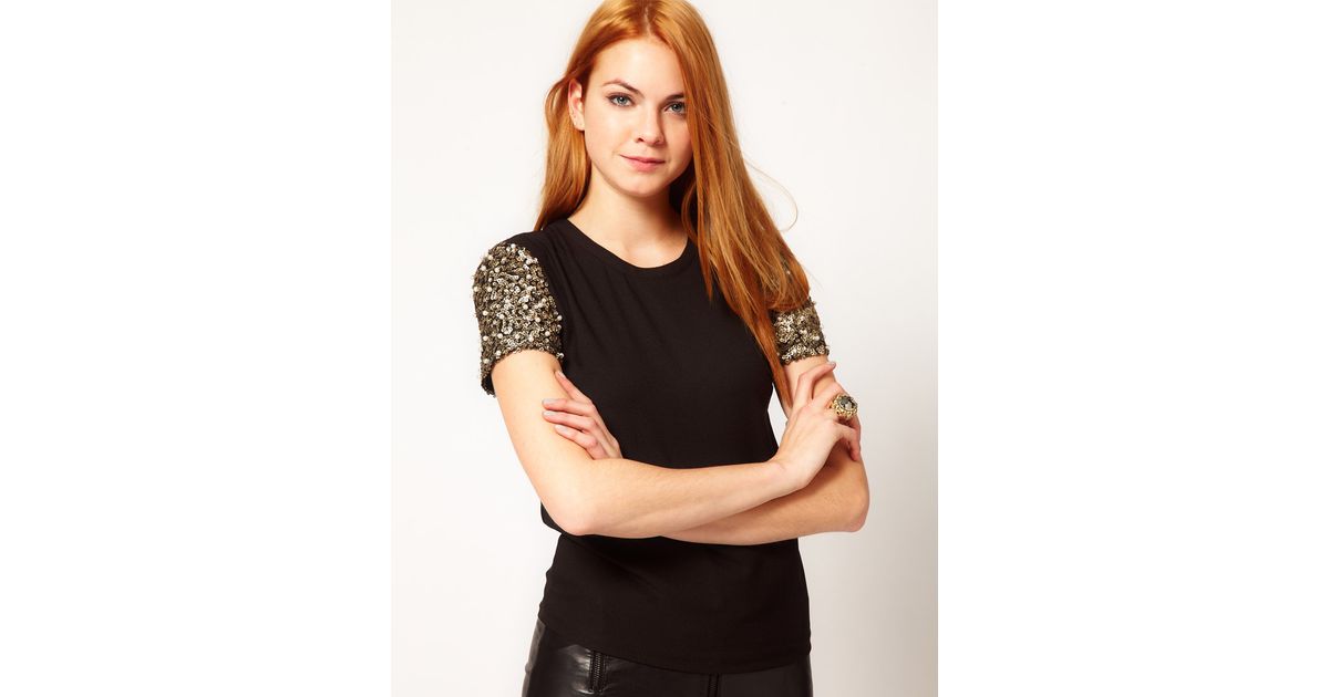 black top with sequin sleeves