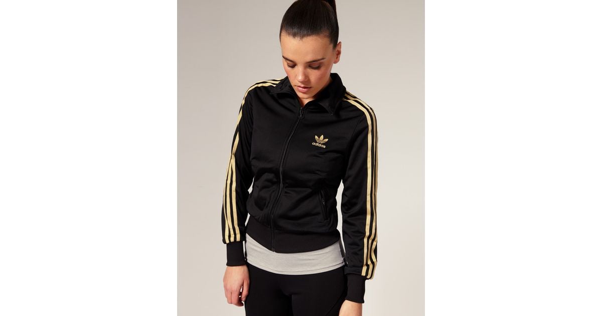 black adidas track jacket with gold stripes