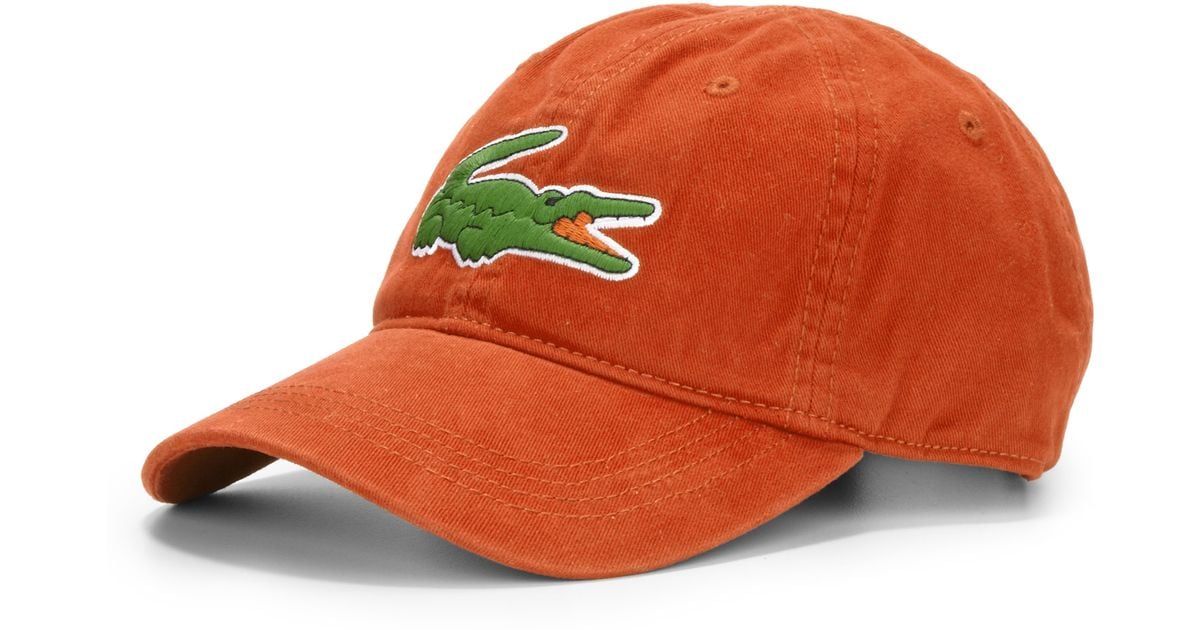 orange lacoste hat