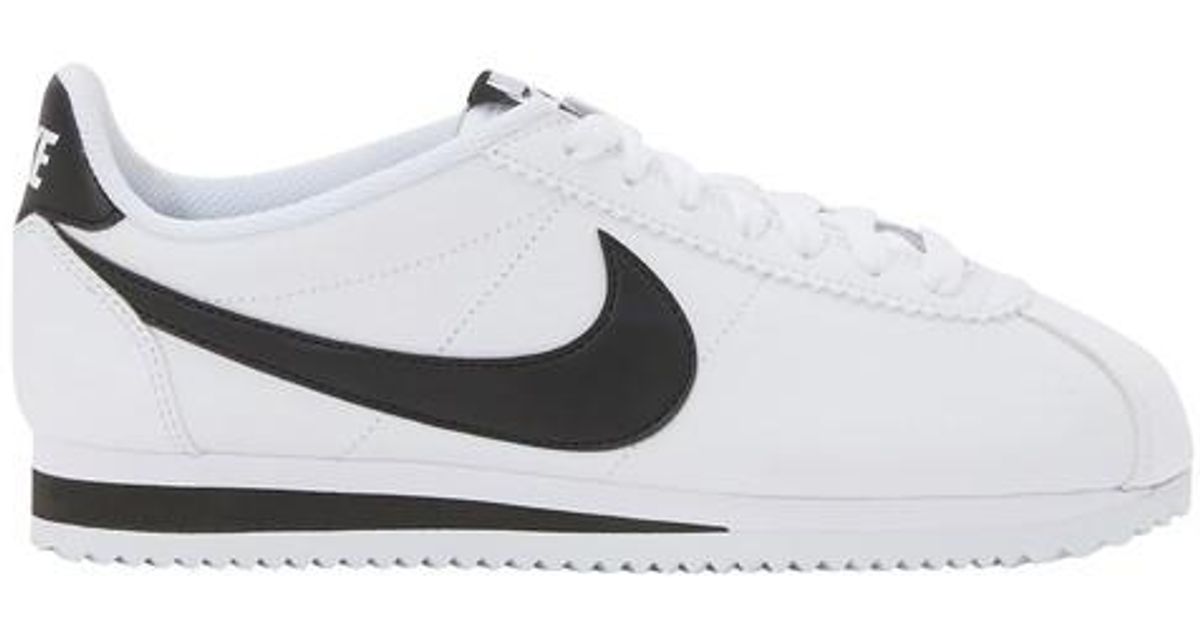 nike cortez leather trainers in white with black swoosh
