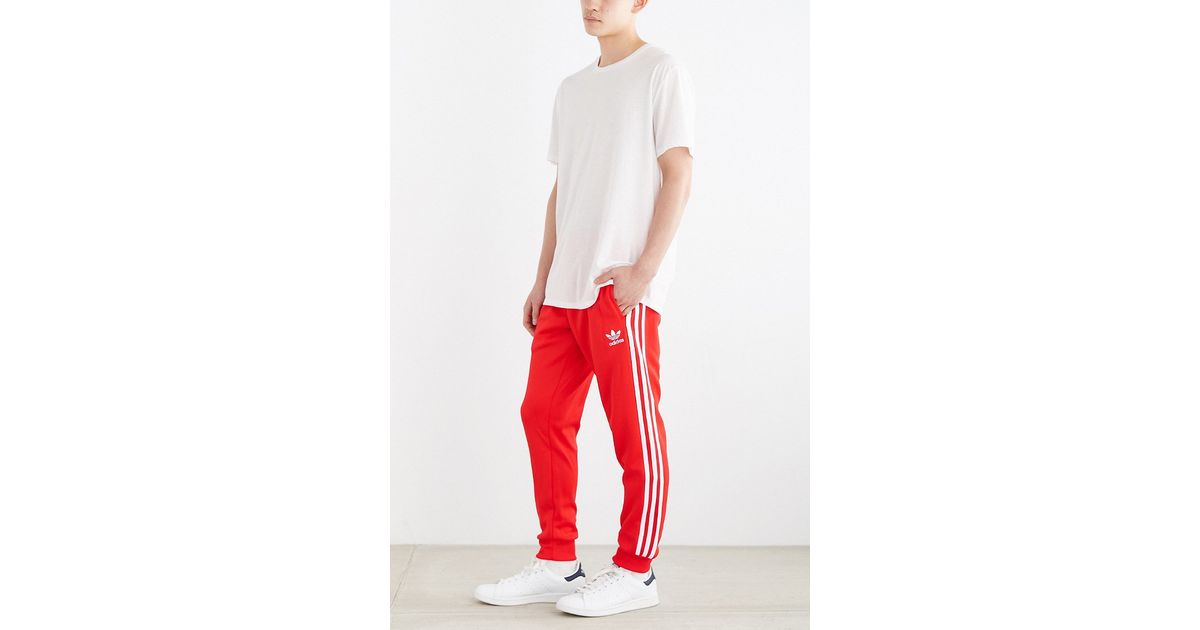 red adidas cuffed track pants