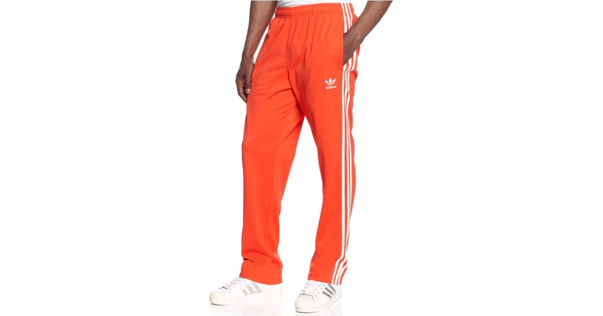 white and orange adidas pants