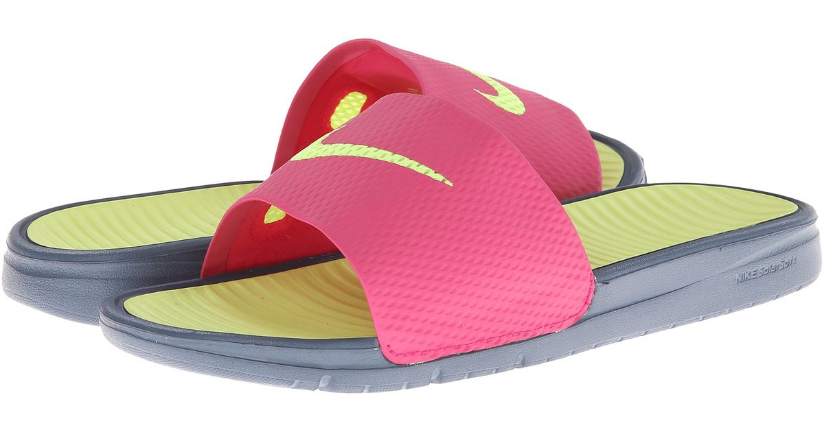 pink and yellow nike slides