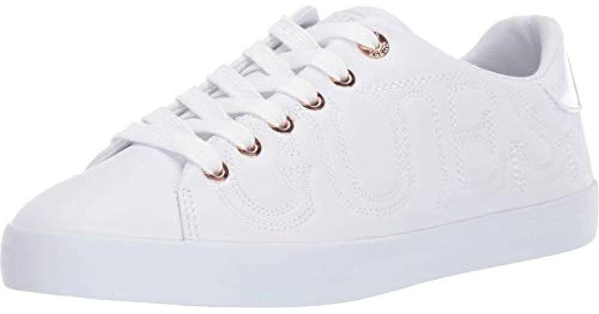 guess white and gold sneakers