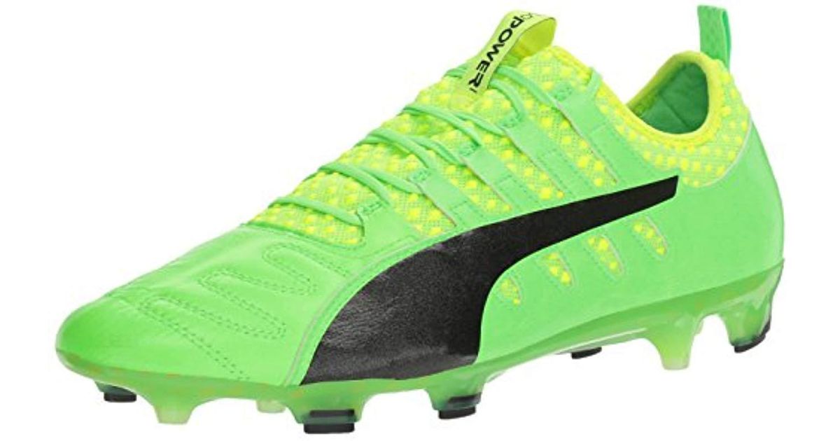 puma green and black football boots
