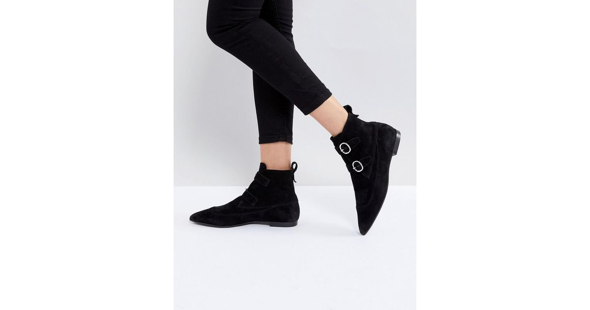 black pointed buckle boots