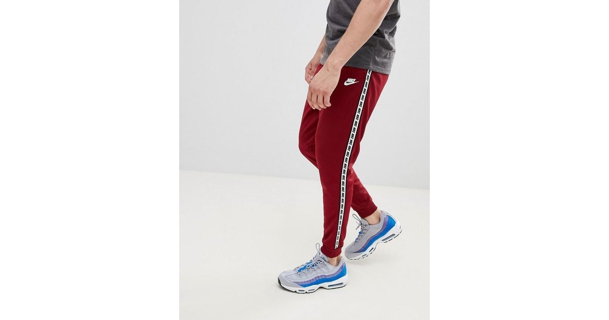 red nike tape joggers