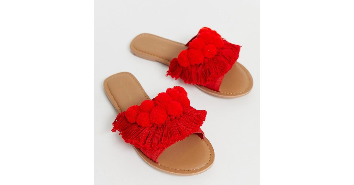 PrettyLittleThing Flat Sandals With Fringe And Pom Pom Detail in Red | Lyst