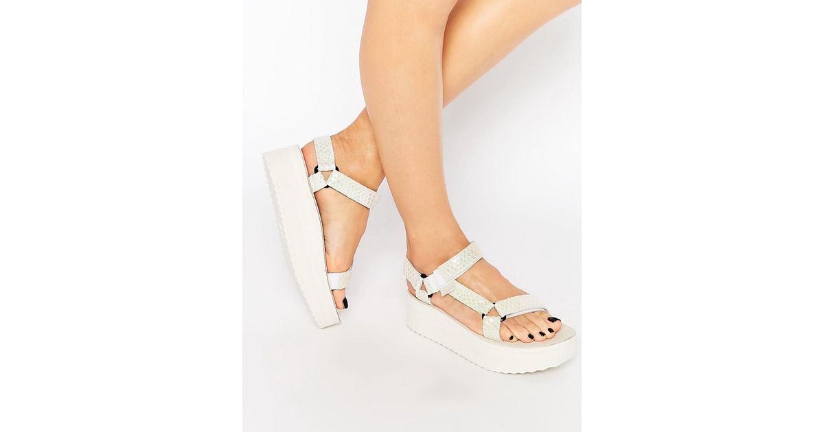 white teva flatforms