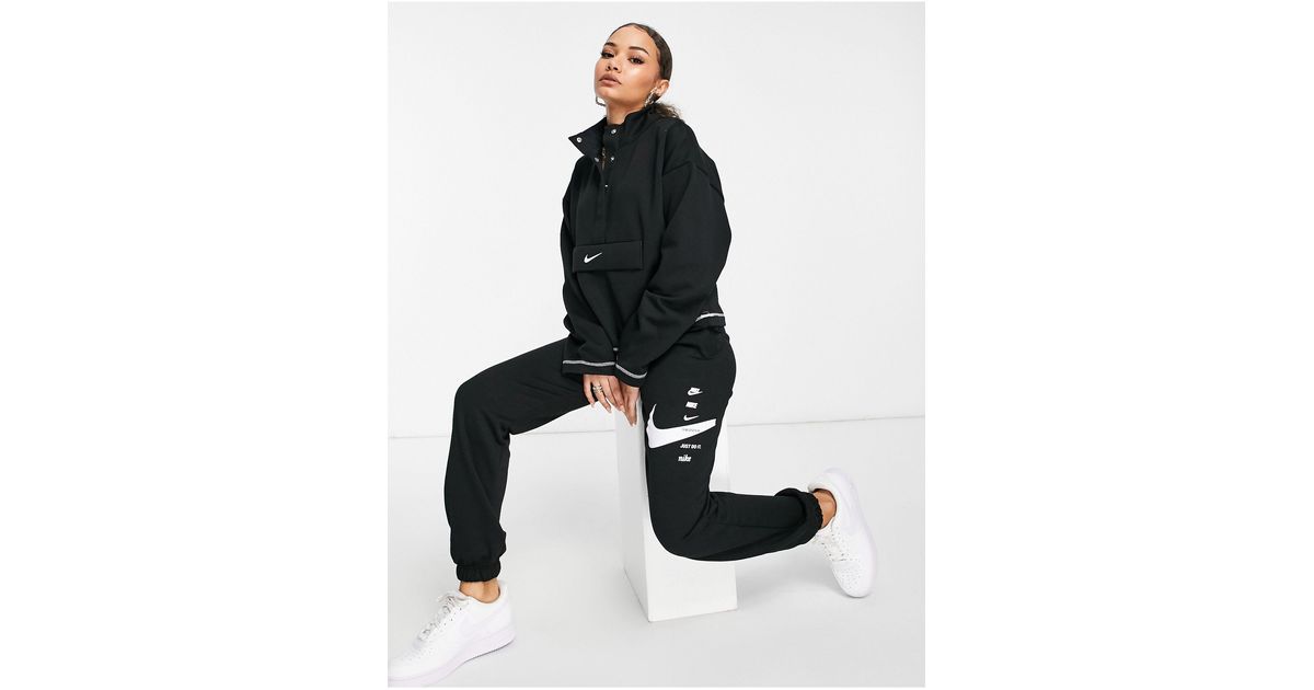 nike mini swoosh oversized trackies in black