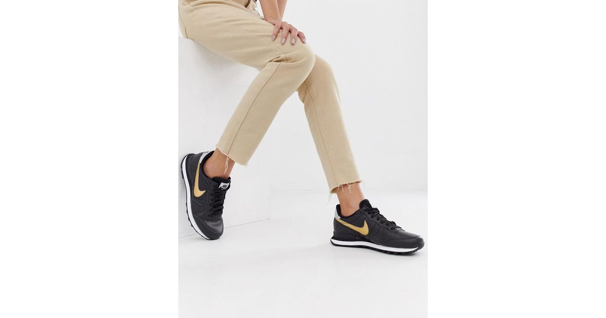 nike black and gold internationalist sneakers