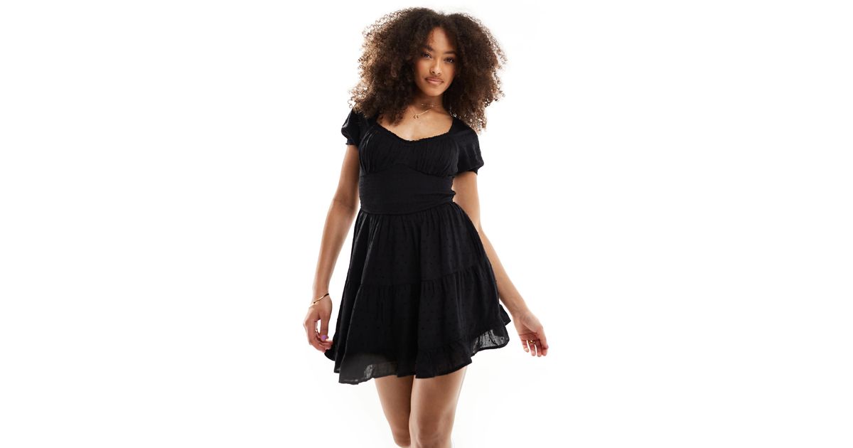 Robe courte smockee a la taille avec poches et short cache Hollister en coloris Noir Lyst