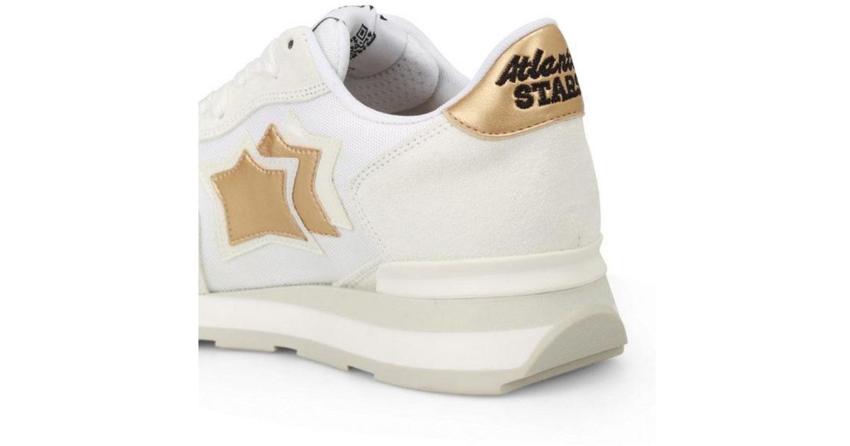 white sneakers with gold stars