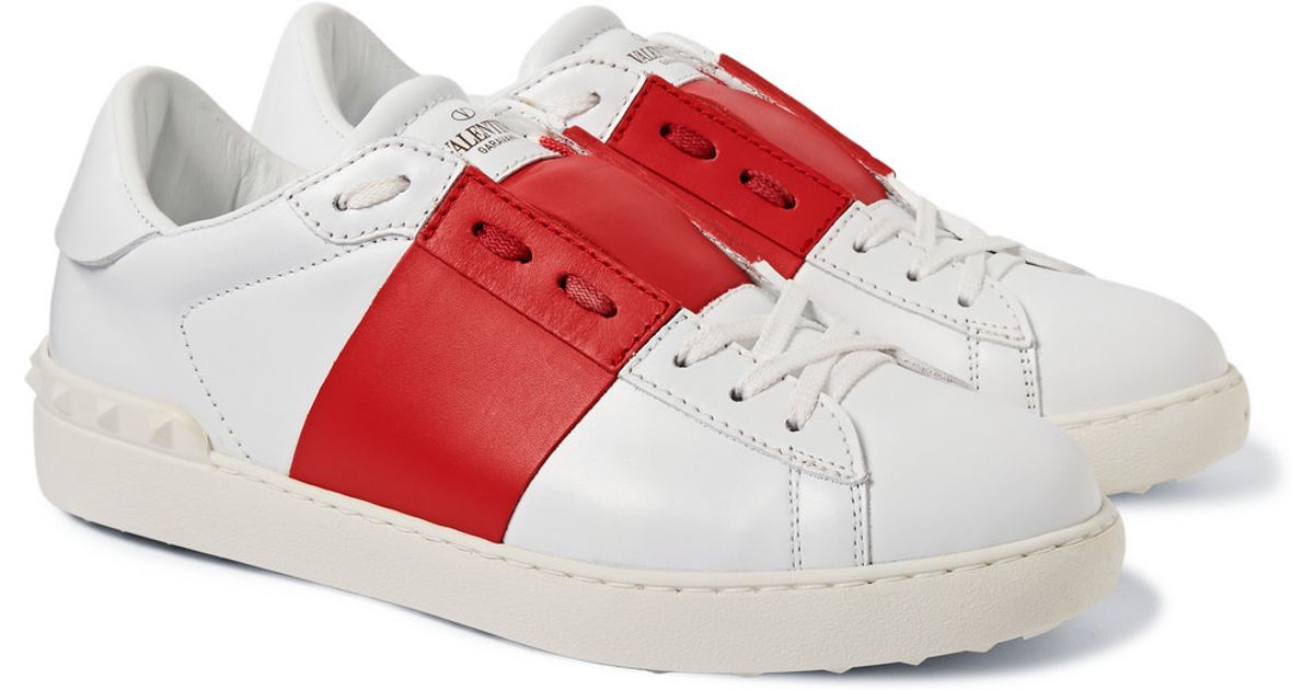 white sneakers red stripe