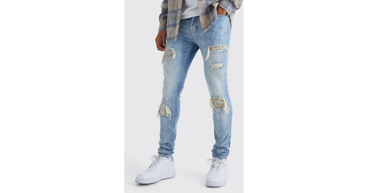 BoohooMAN Skinny Exploded Knee Stacked Biker Jeans in Blue for Men