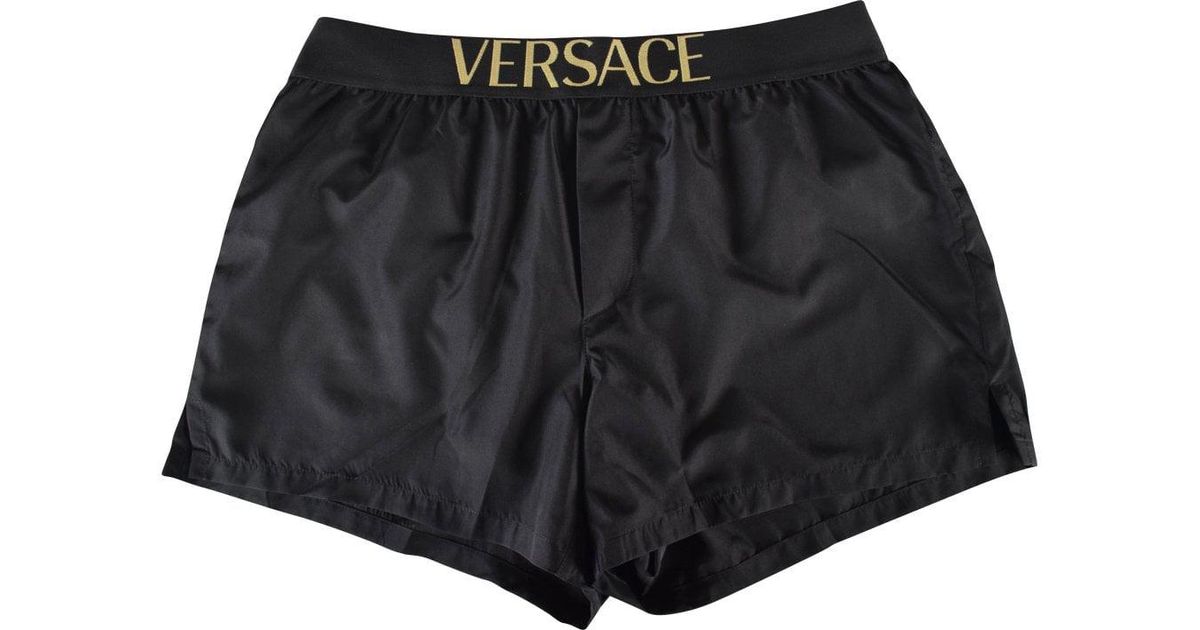 black and gold versace swim shorts