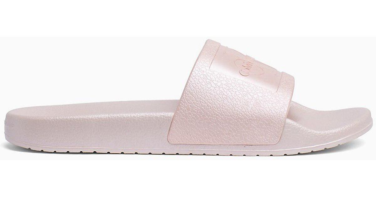 pink and white calvin klein sliders