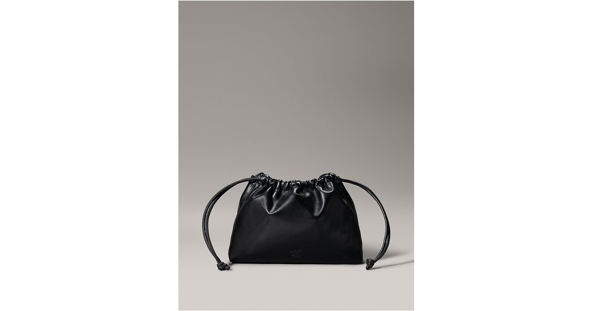 Calvin Klein Calvin Klein Monogram Drawstring Crossbody Bag in Gray | Lyst