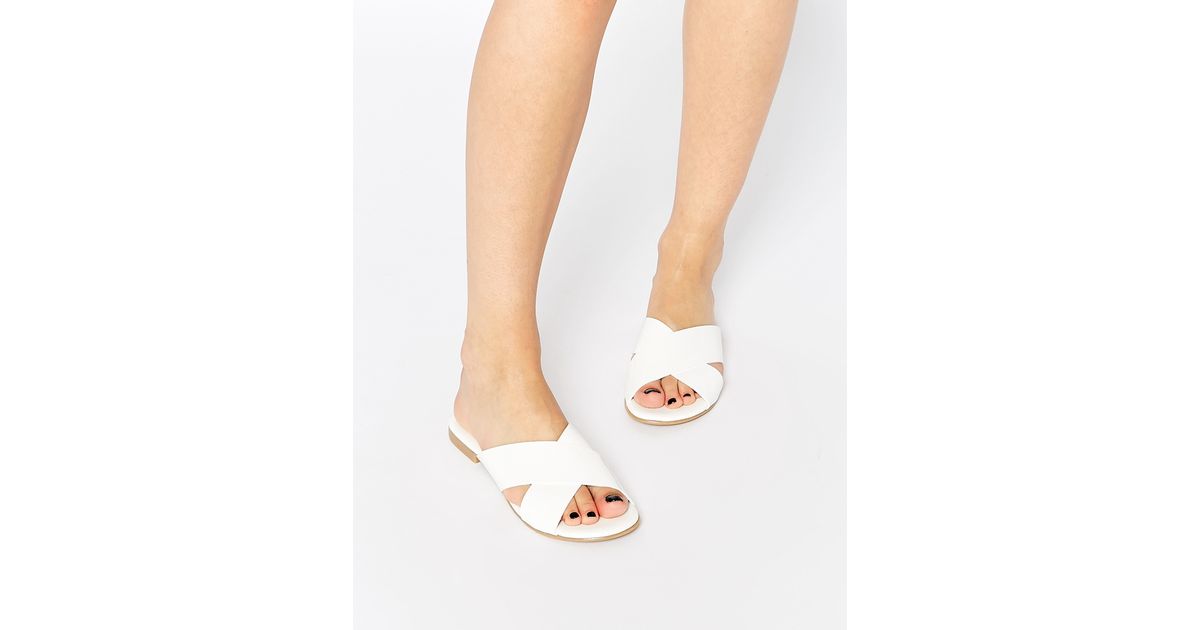 white cross flat sandals