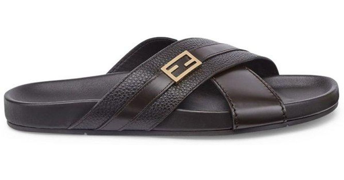 Tan suede Jimmy Choo crossover sandals with brown wood platforms and heels and buckle closures 