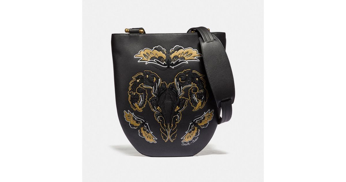 coach sling bag with tattoo