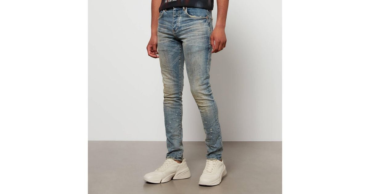 https://cdna.lystit.com/1200/630/tr/photos/coggles/d6e982bb/purple-brand-Blue-P002-Paint-splattered-Faded-Stretch-denim-Skinny-Jeans.jpeg