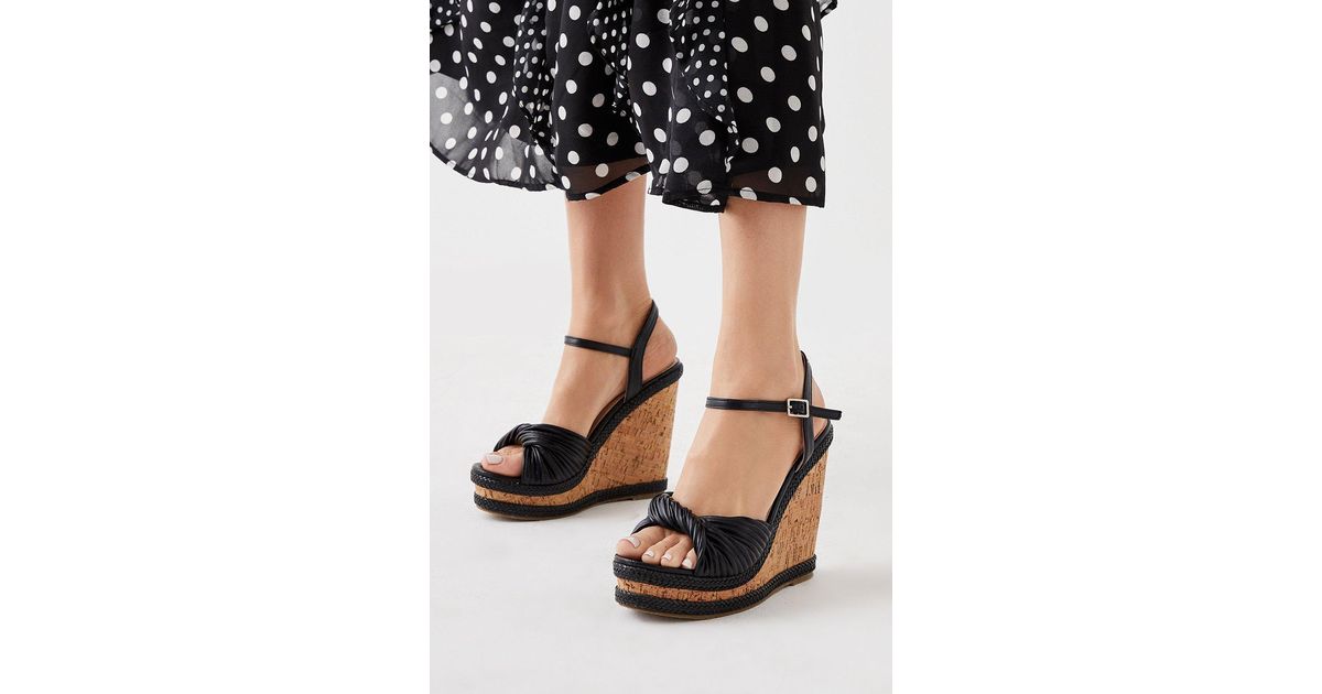 Faith deals black wedges