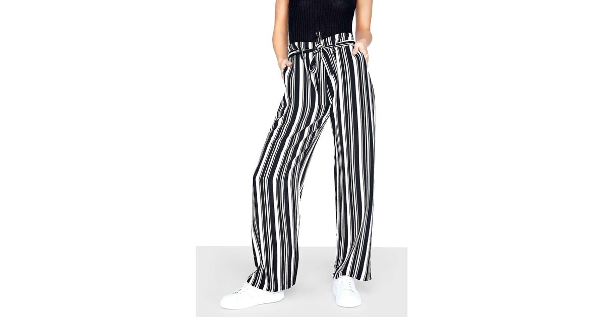 white and black striped trousers