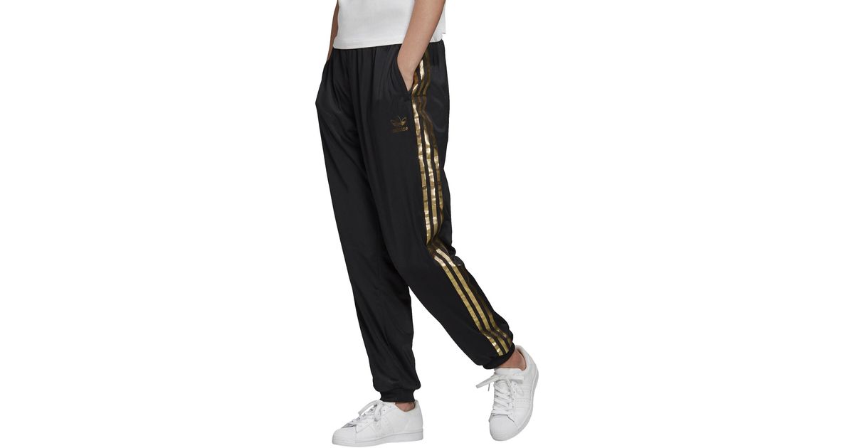gold adidas track pants