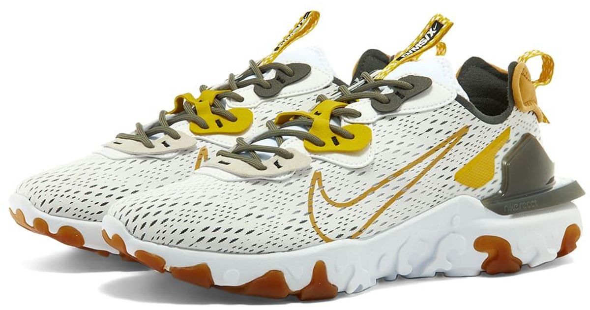 white and orange nike react vision