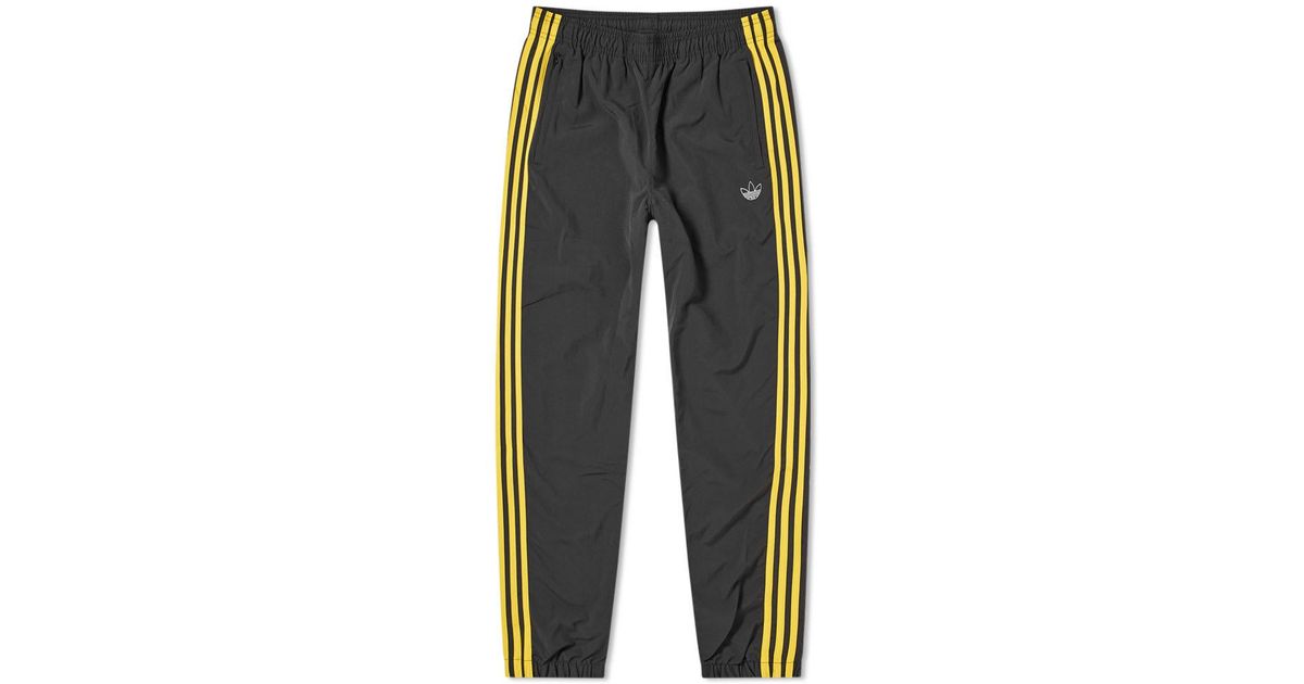 yellow and black adidas pants