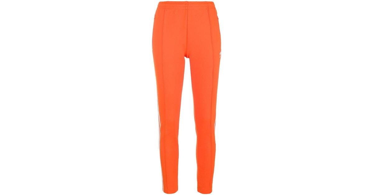 adidas sst track pants orange