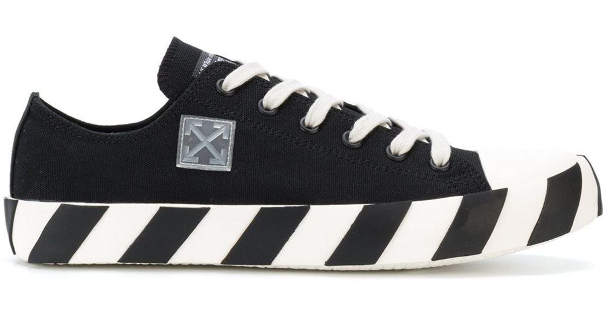 white tennis shoes with black stripes