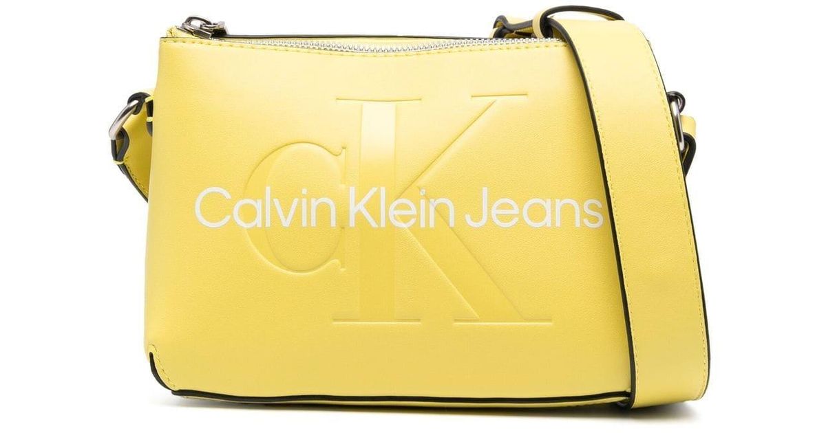 Calvin Klein Embossed-logo Faux-leather Crossbody Bag in Yellow | Lyst