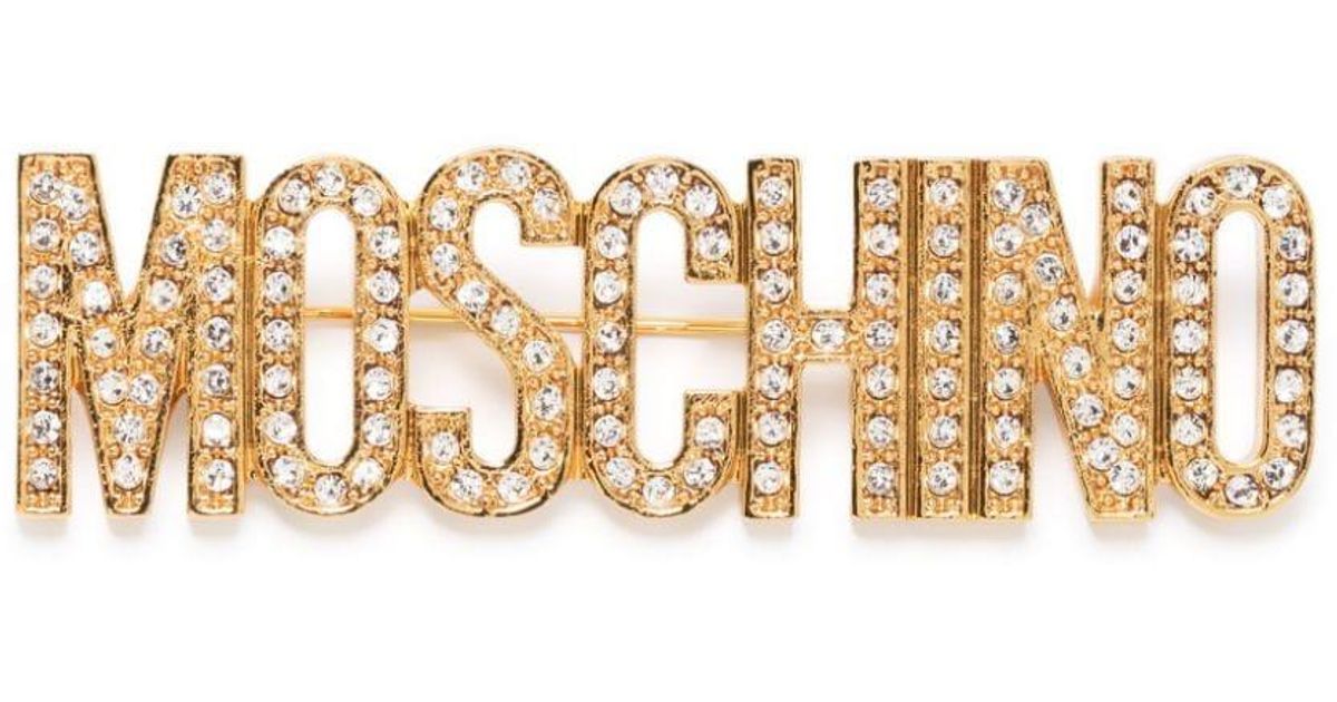 Moschino Crystal-embellished Logo Brooch in Natural | Lyst