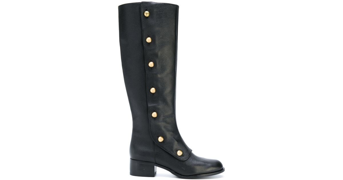 black boots with gold buttons