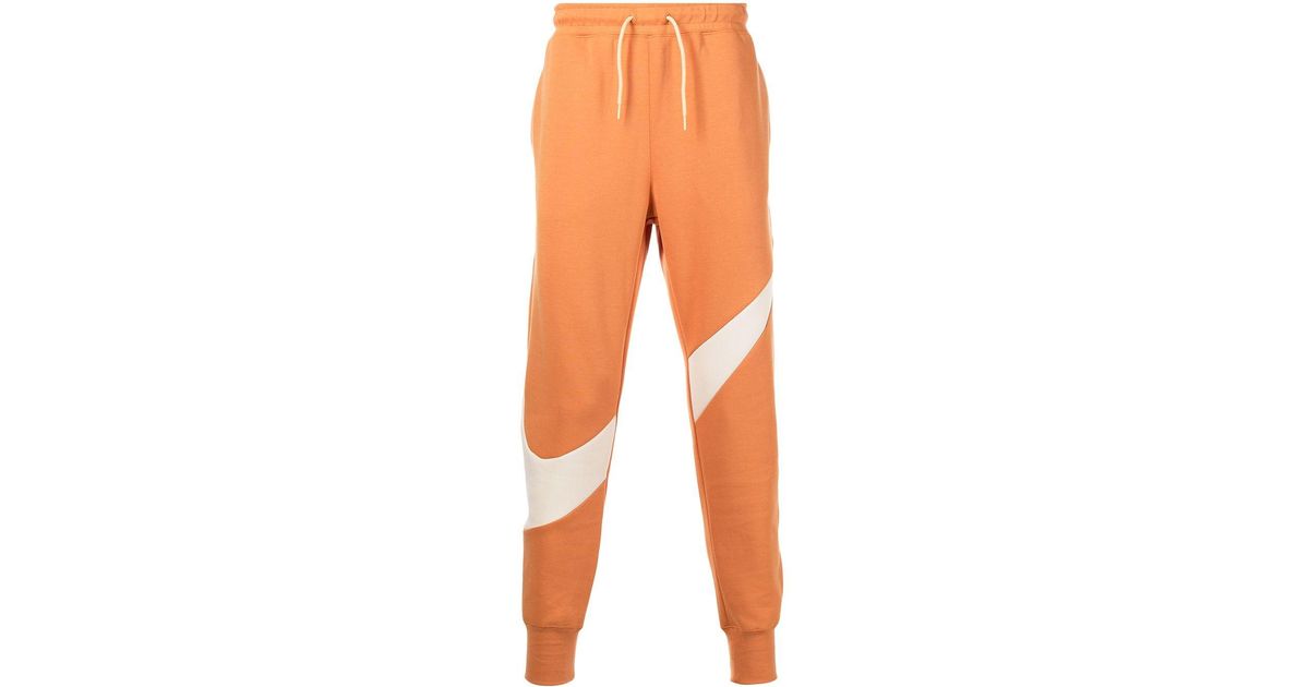 Nike Swooshprint Fleece Track Pants in Orange for Men Lyst