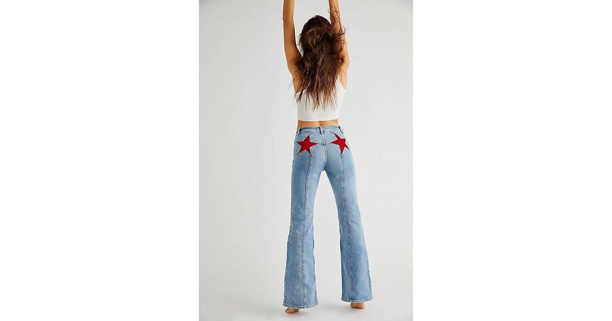Free People Firecracker Flare Jeans At Free People In Mid Stone Wash, Size:  24 in White