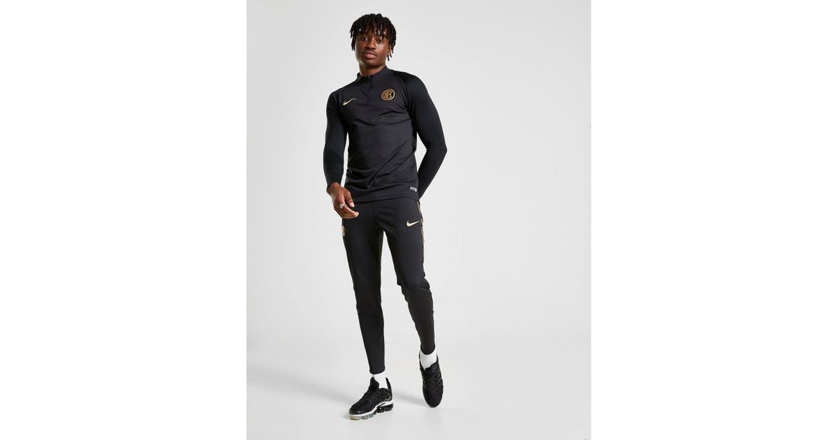 black and gold nike track pants