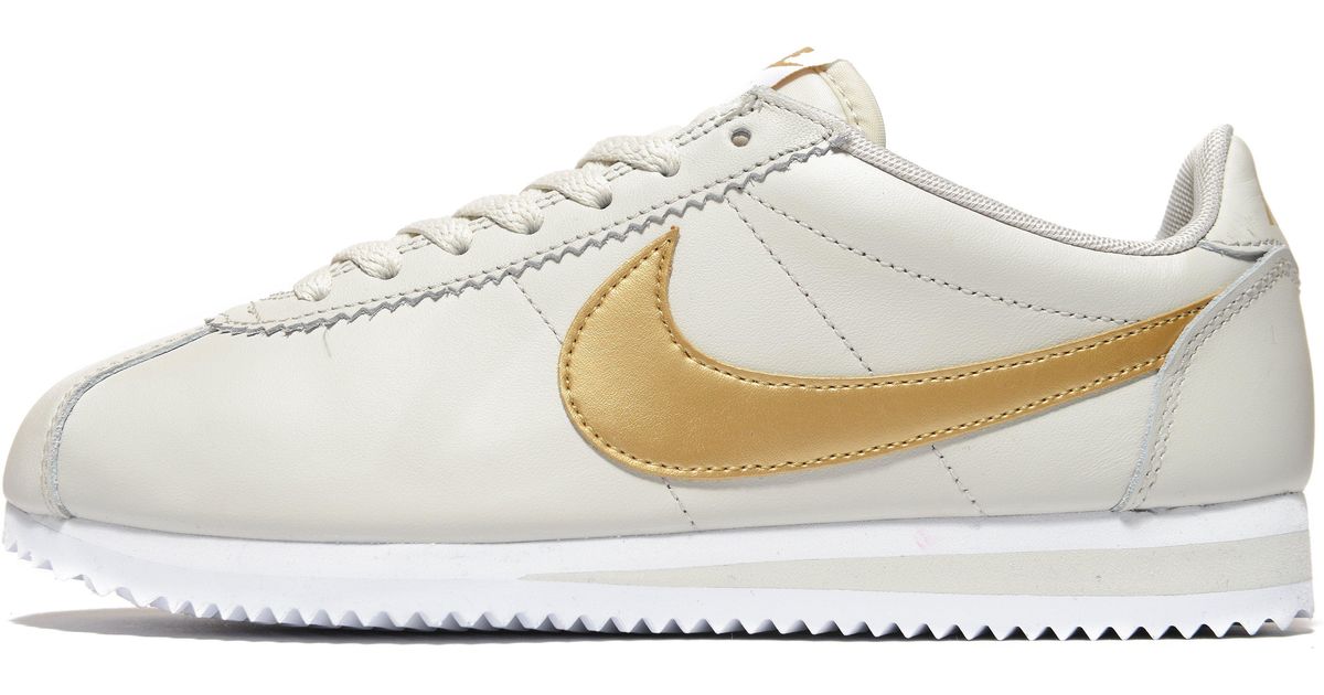nike cortez gold and white