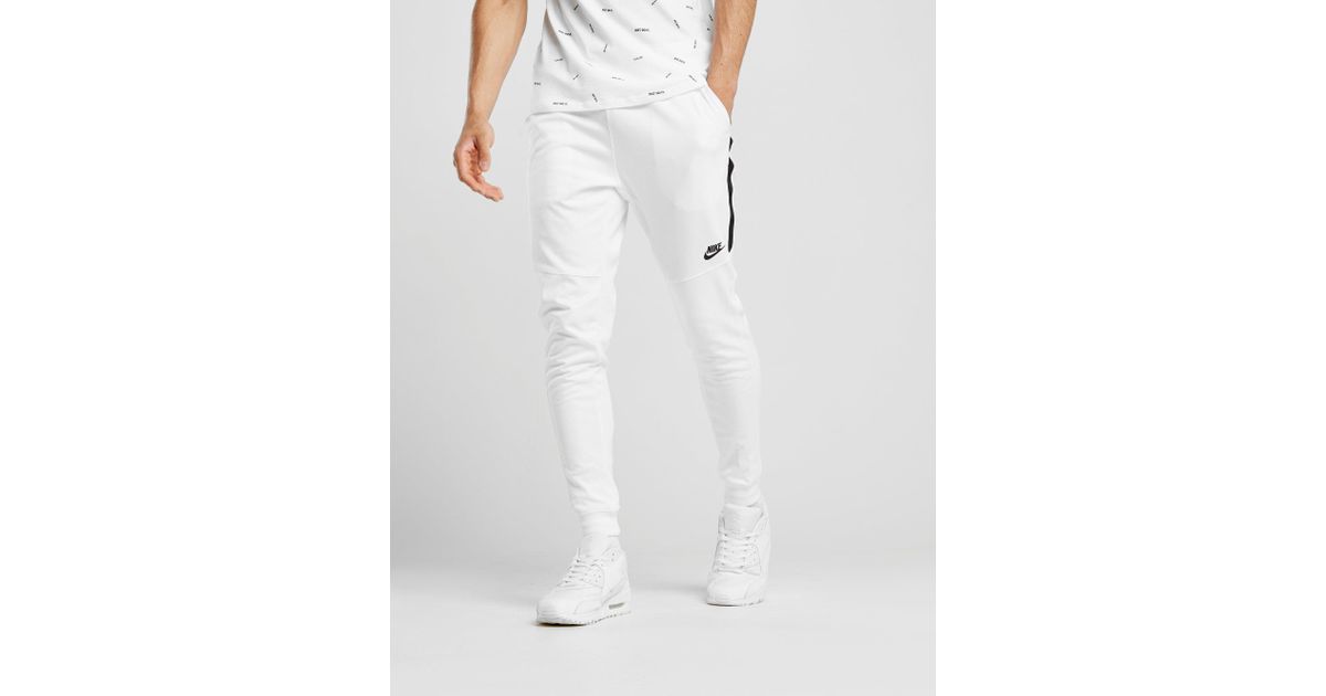 white nike trousers