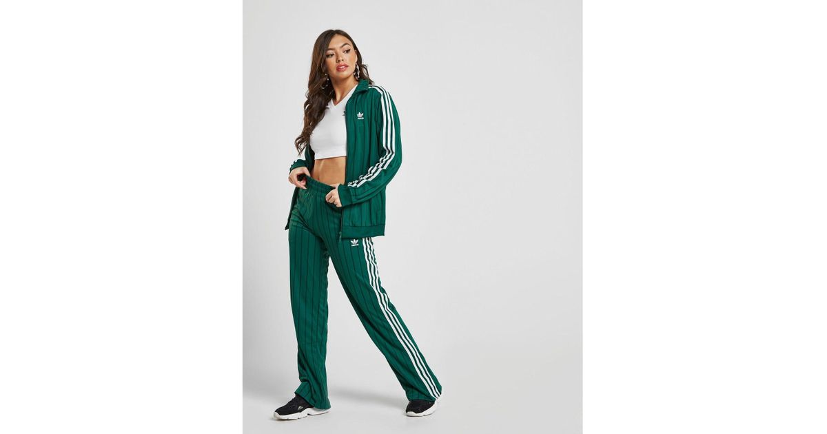 green and white adidas track pants
