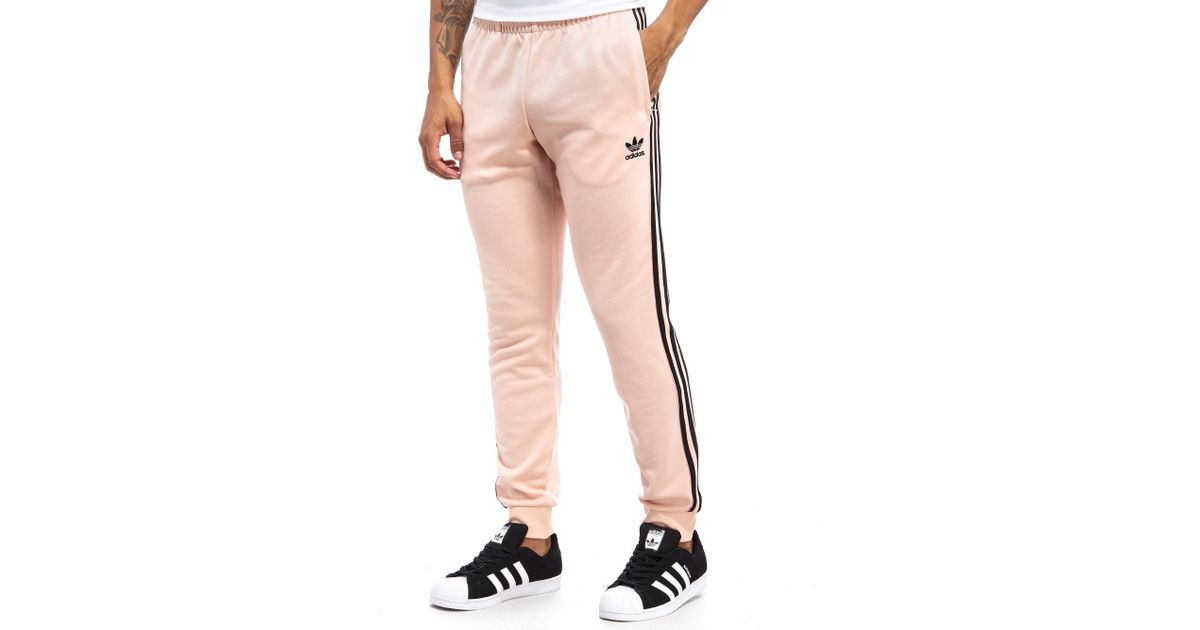 pink and black adidas pants