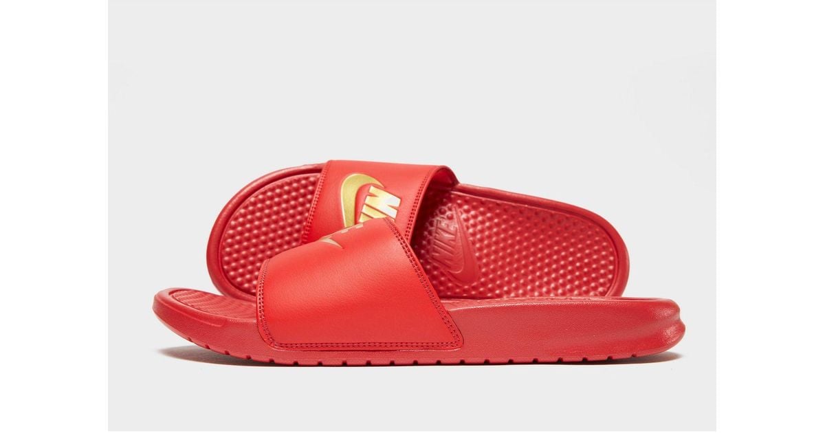 red and gold nike flip flops