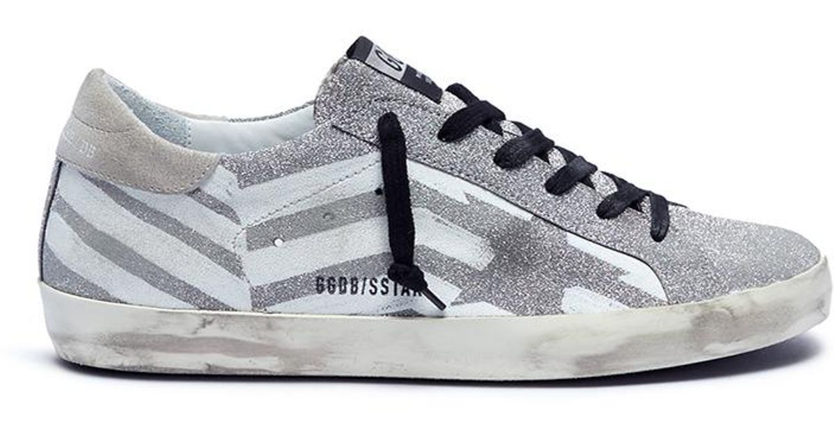 white shoes with golden stripes